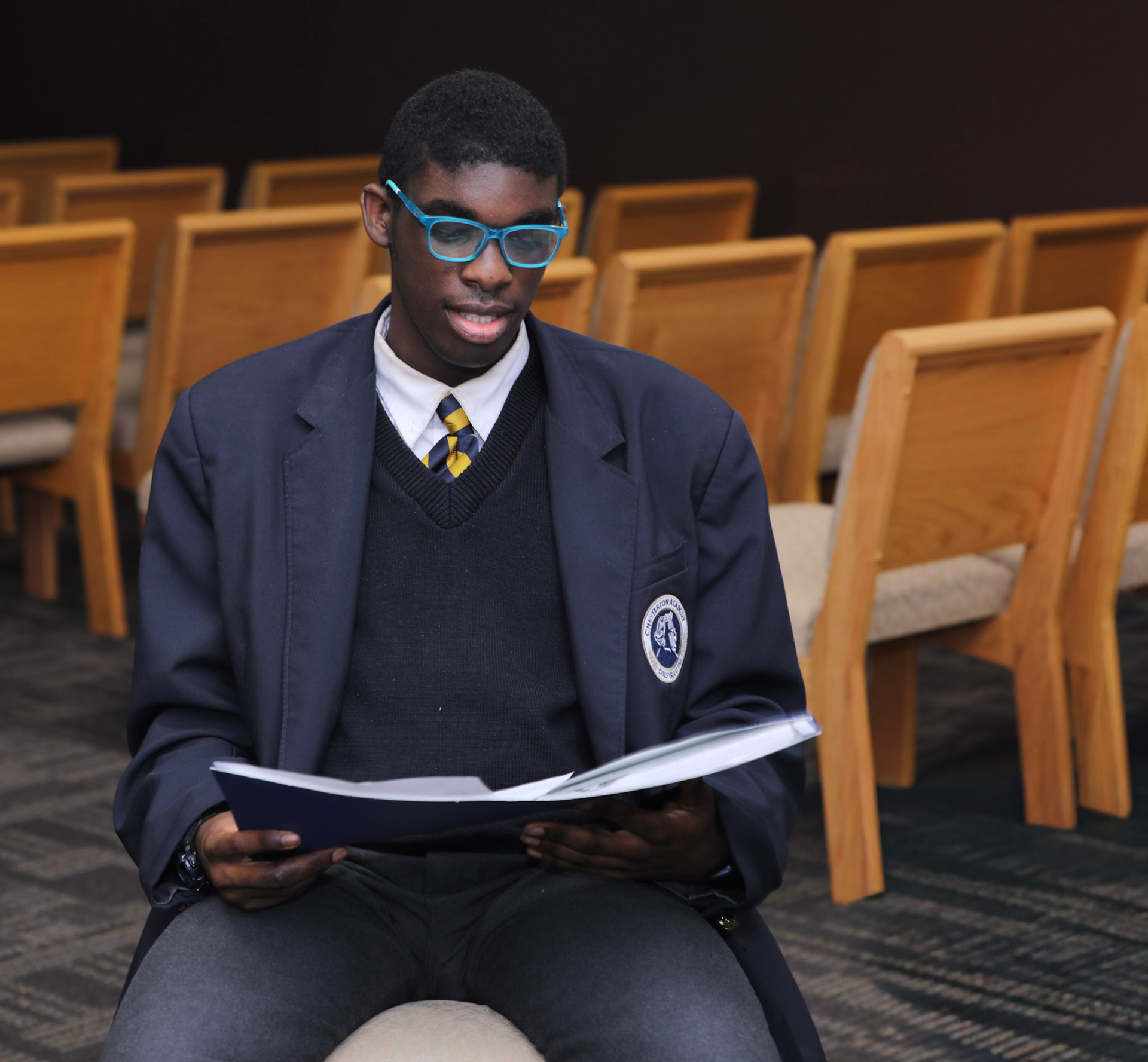A student reading in the school assembly hall